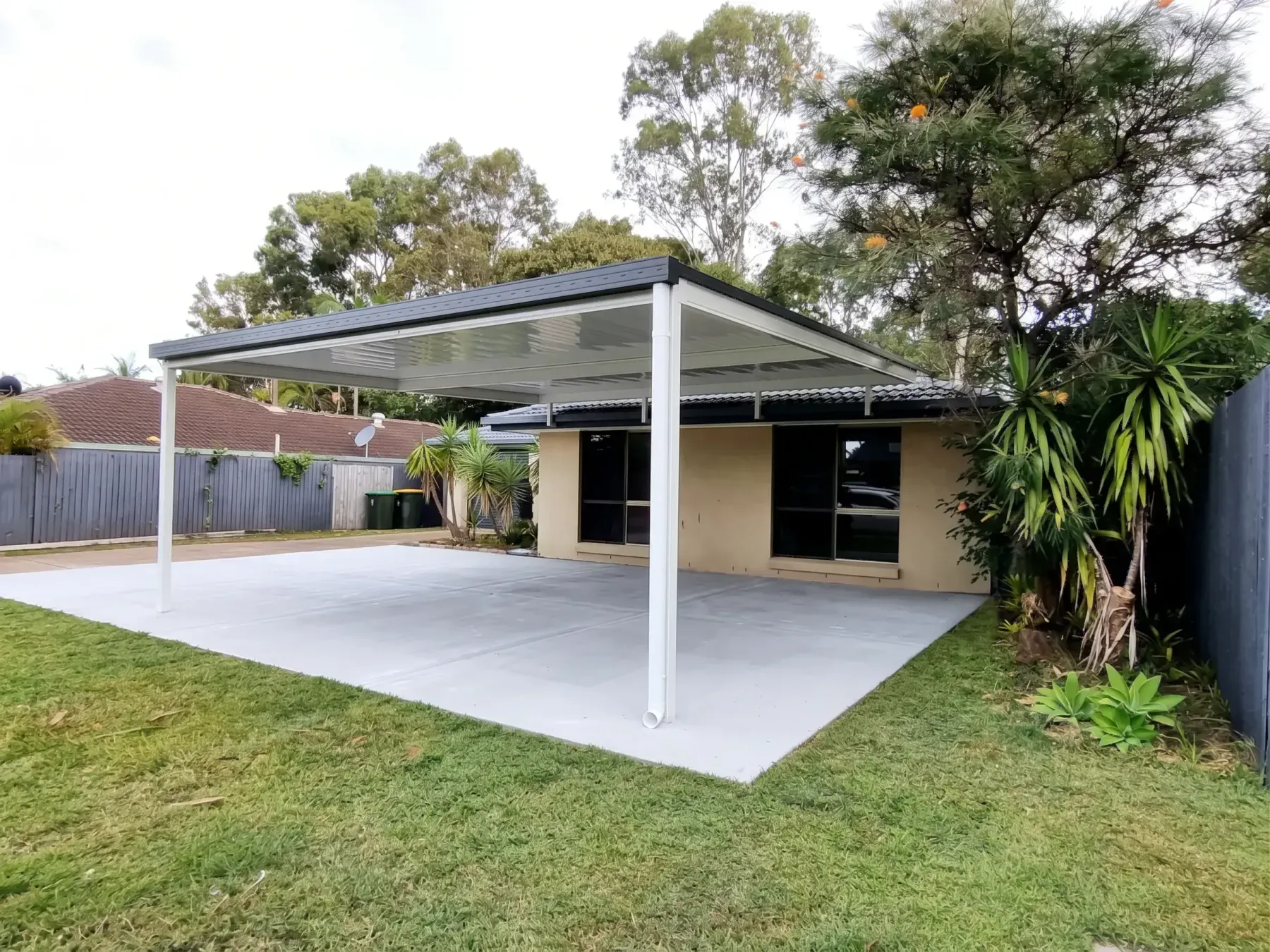 Carport over a new concrete slab with a lawn in front