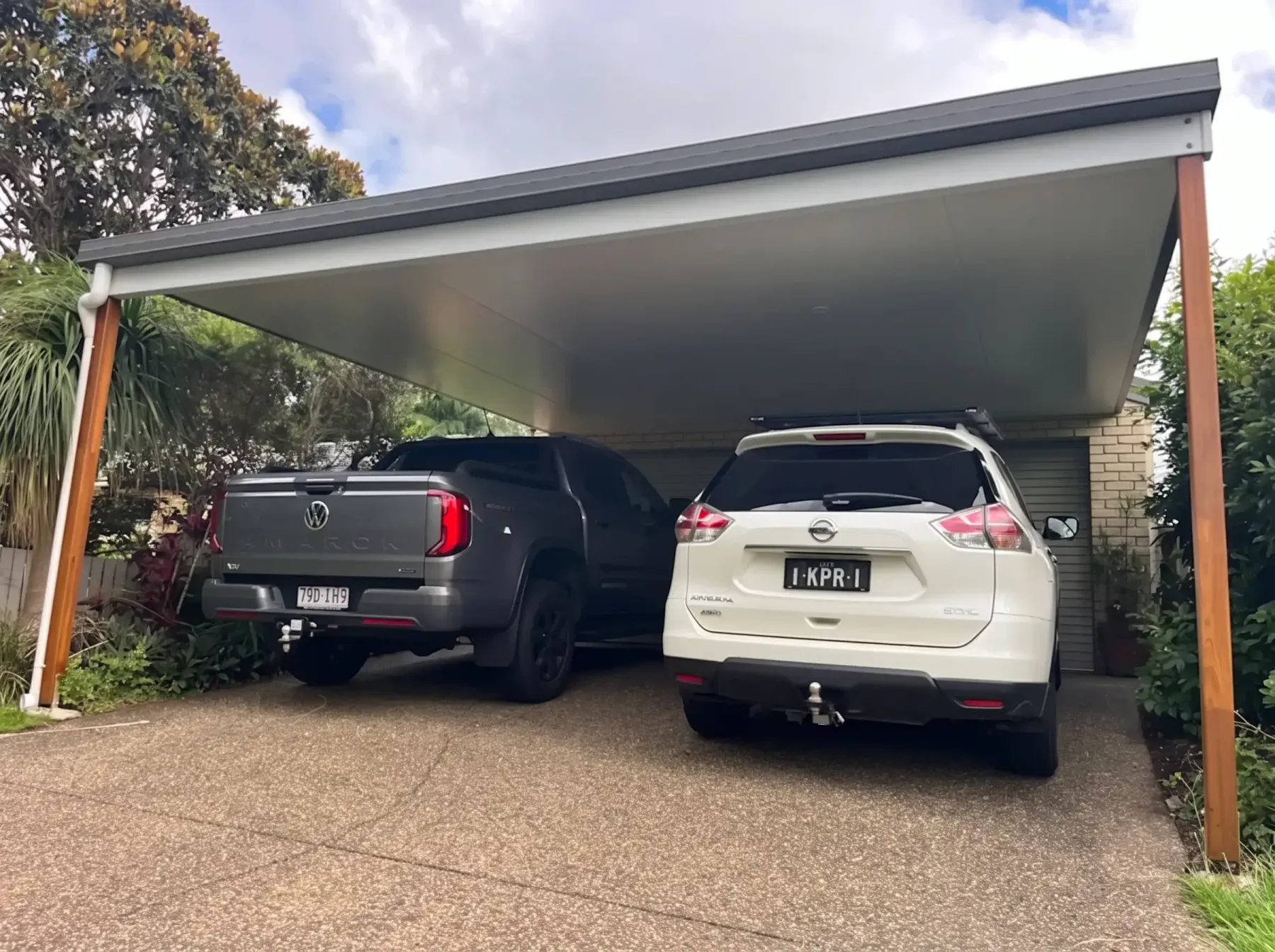 Dark-framed double carport over two cars
