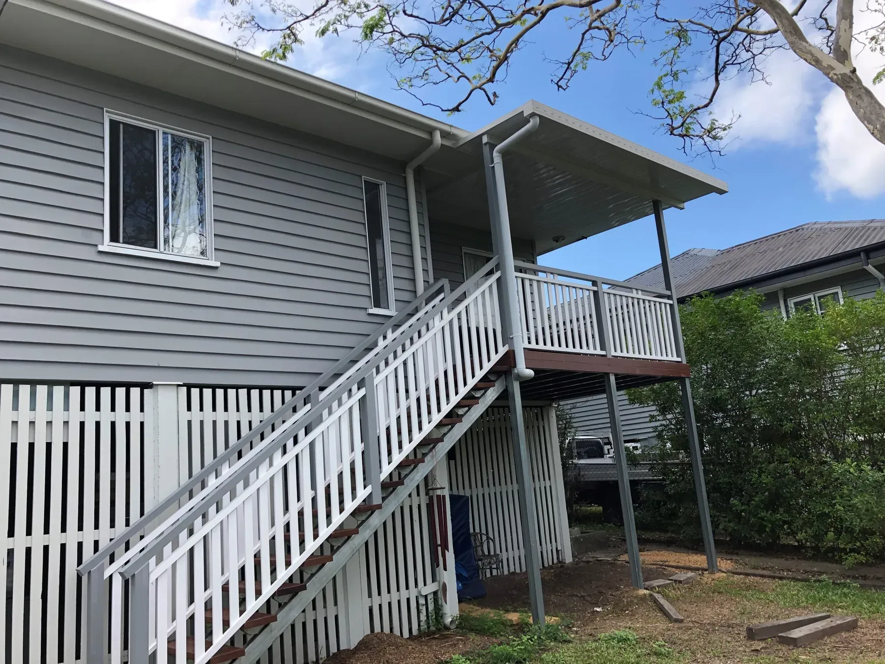 Elevated deck and stairs on a weatherboard home