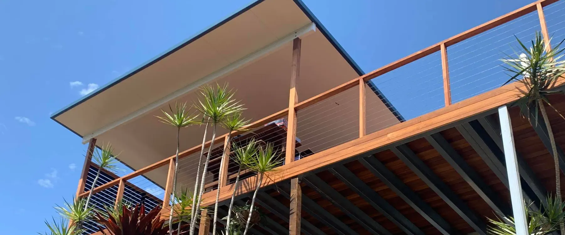 Elevated deck under a raked patio roof