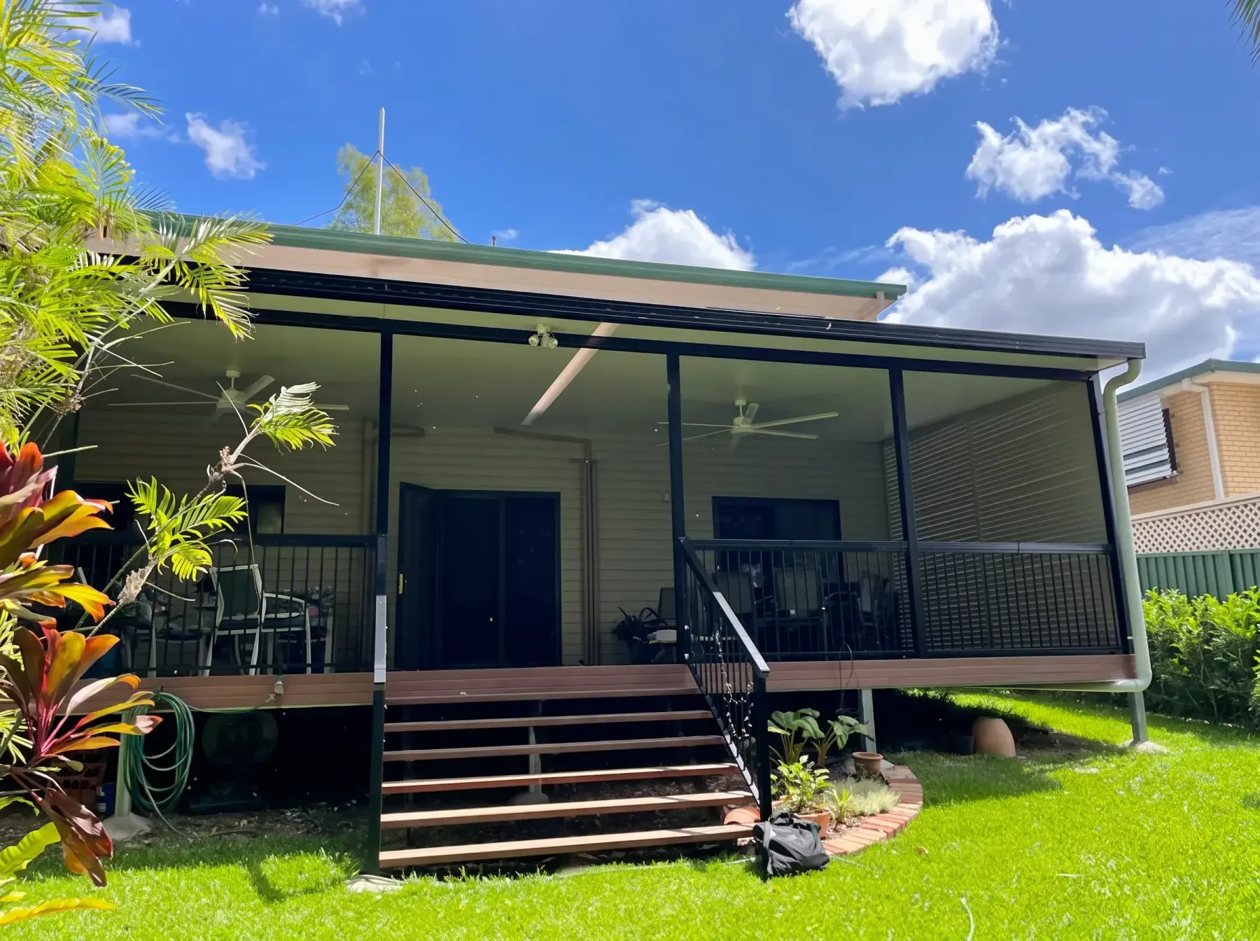Patio roof over a raised deck with stairs to the lawn