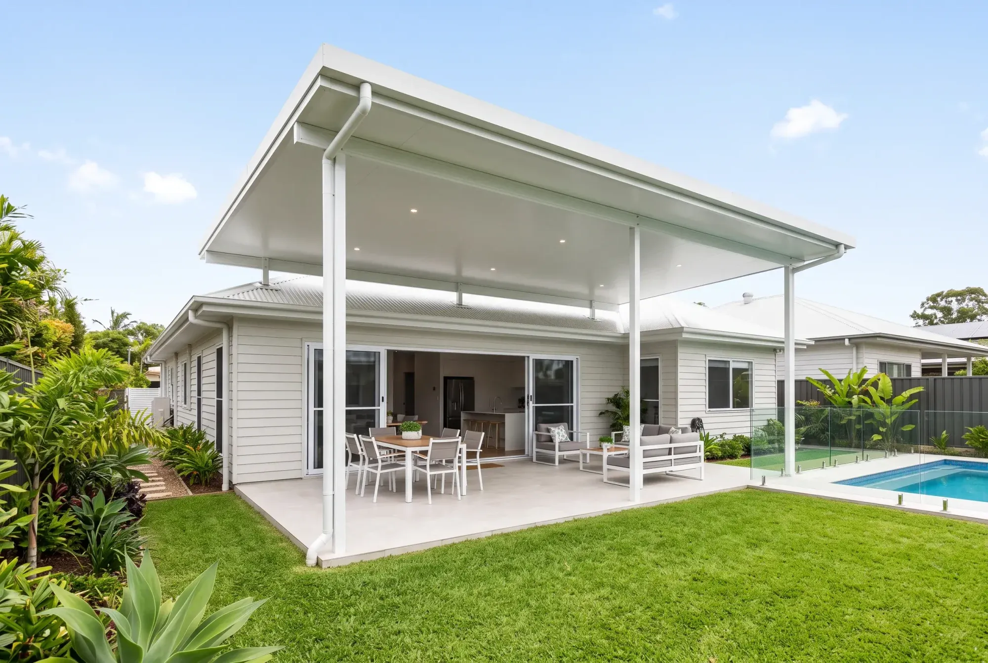 Insulated flyover patio over outdoor dining beside a pool