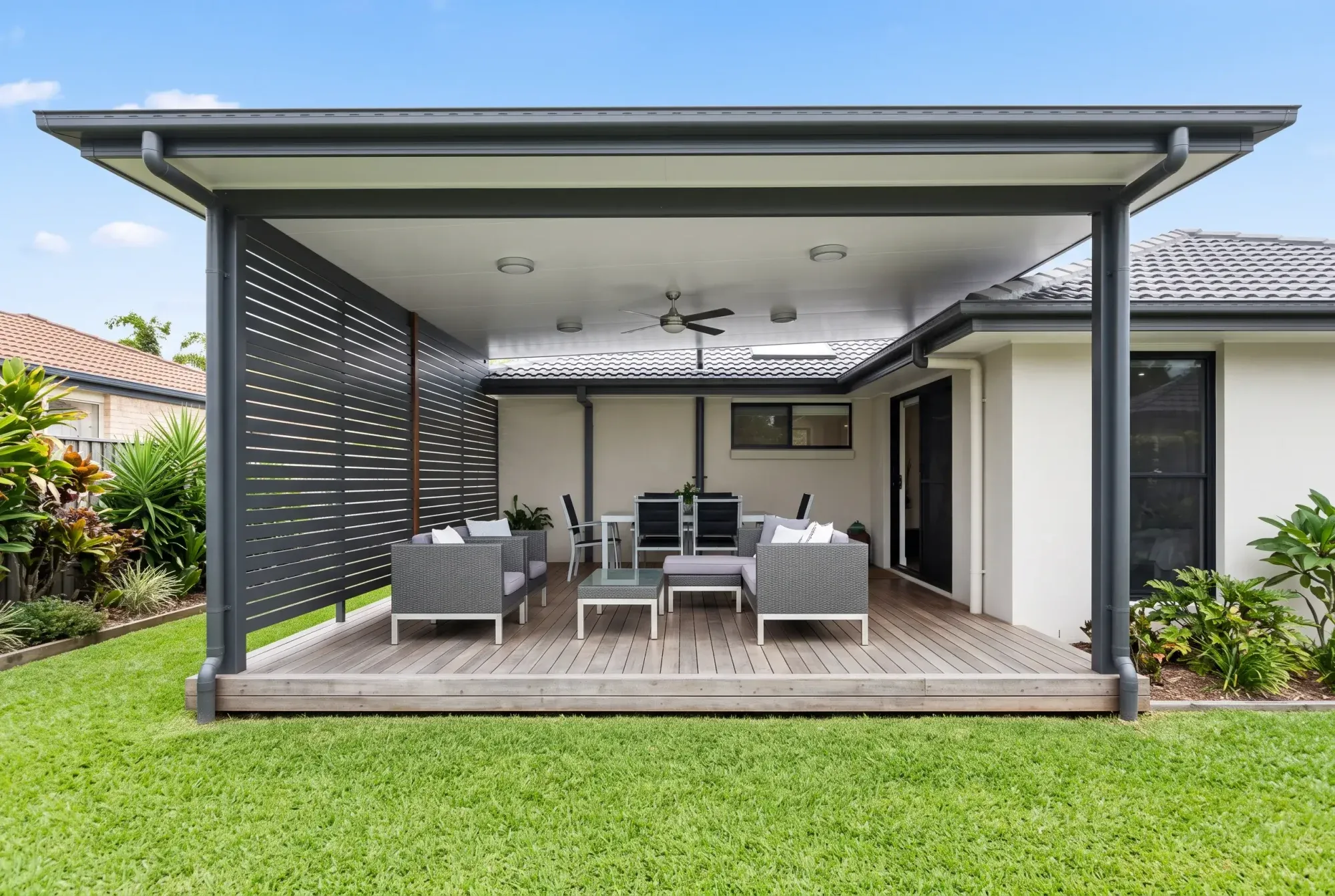 Low hardwood deck under an insulated roof at the back of a home