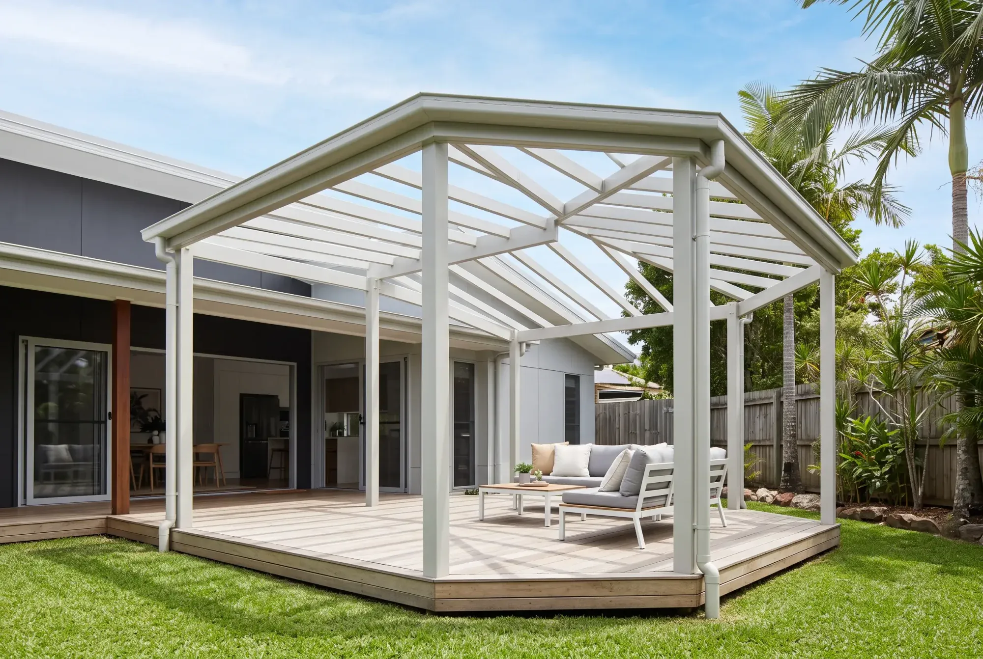 Open steel pergola over a timber deck in a garden