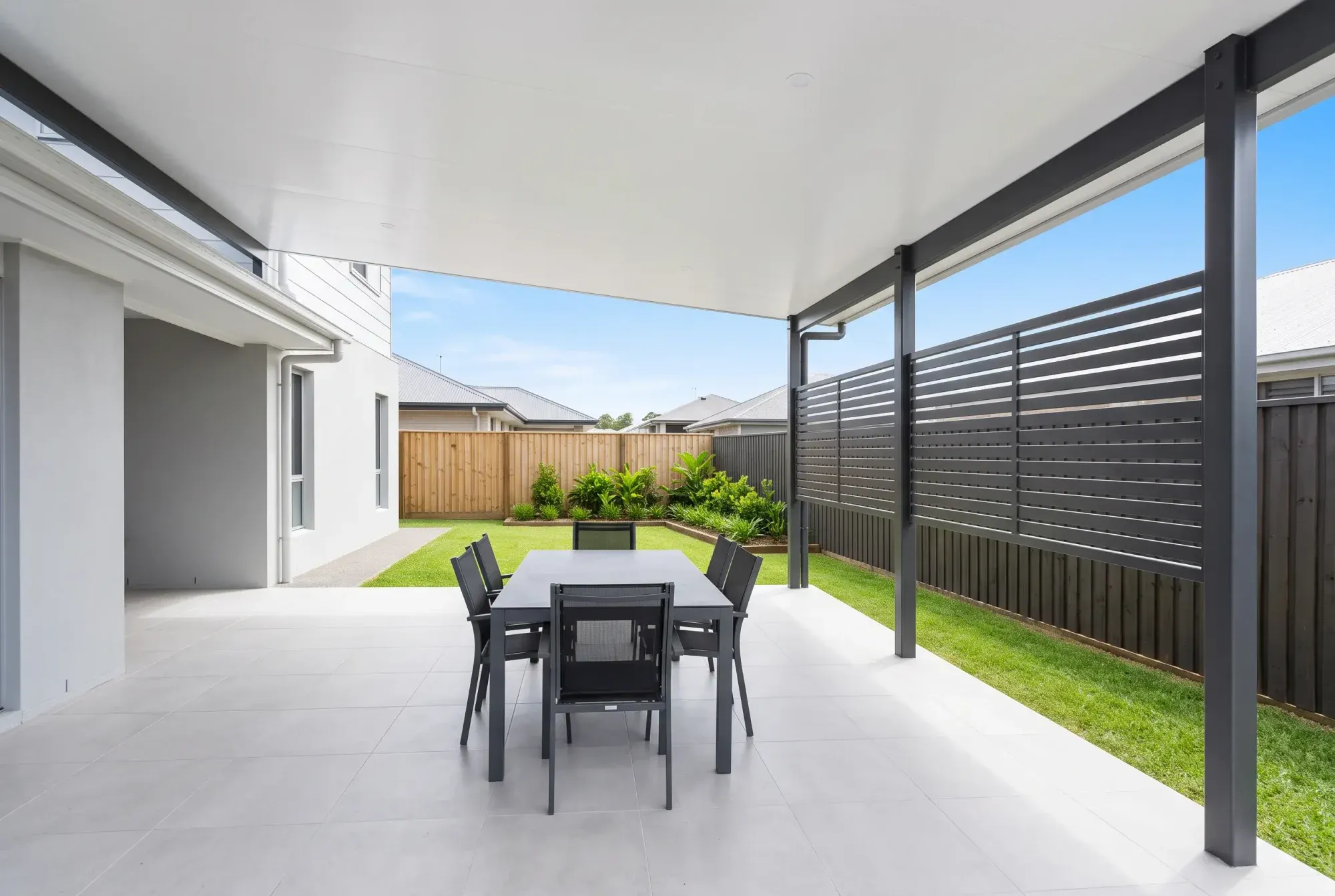Patio with slatted privacy screens along one side
