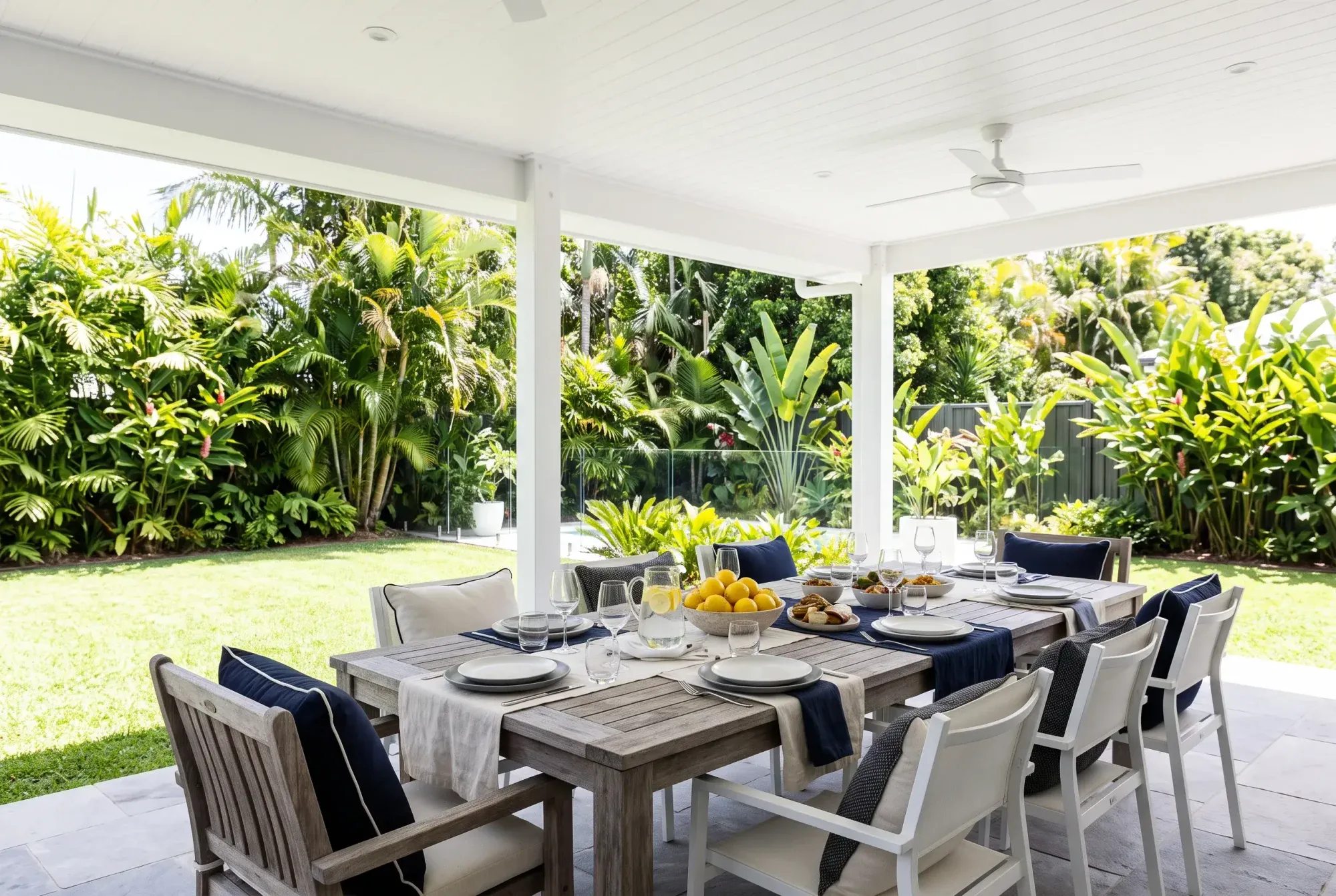 Outdoor table set for lunch under a white patio roof