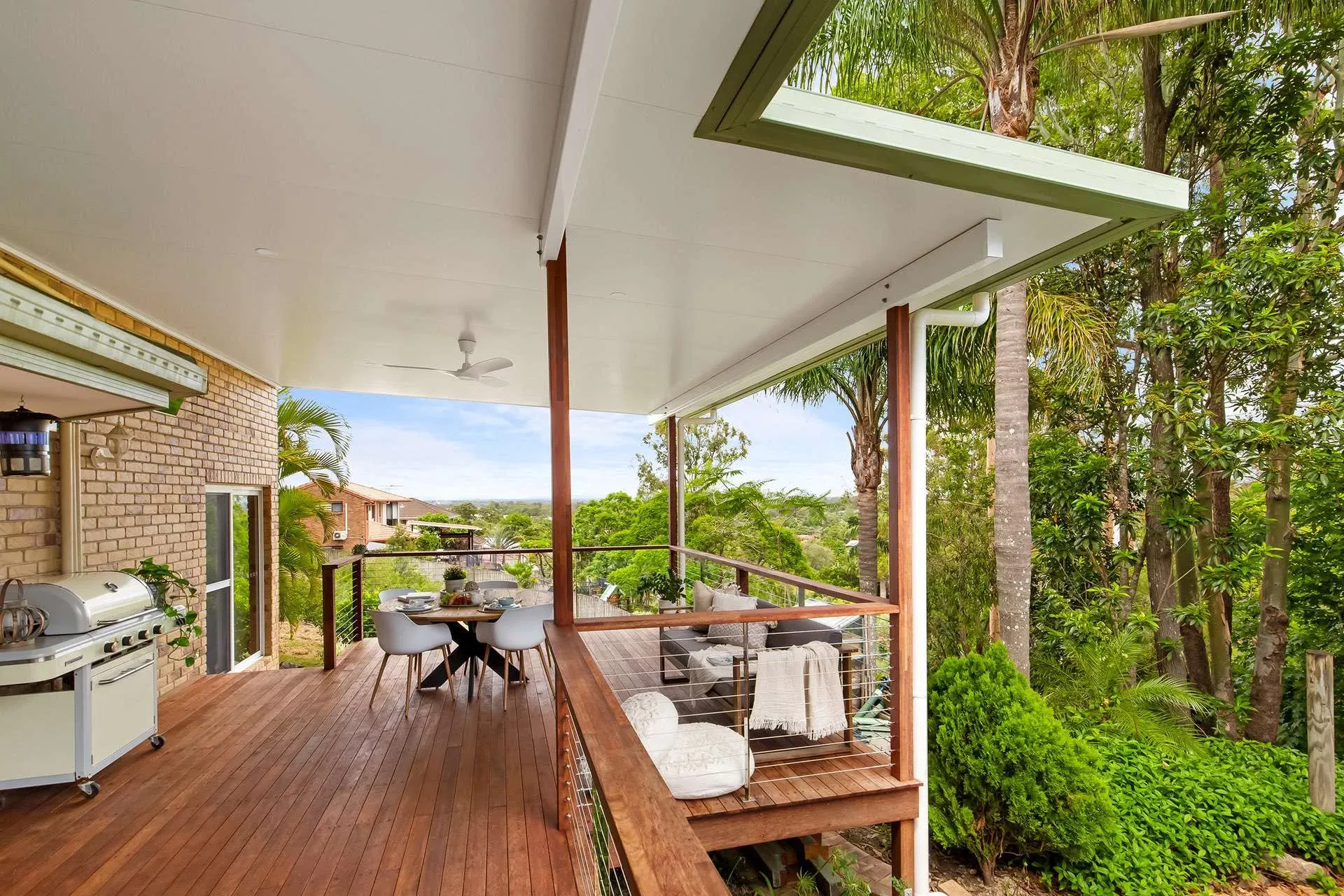 Timber-topped steel deck with an outdoor dining setting