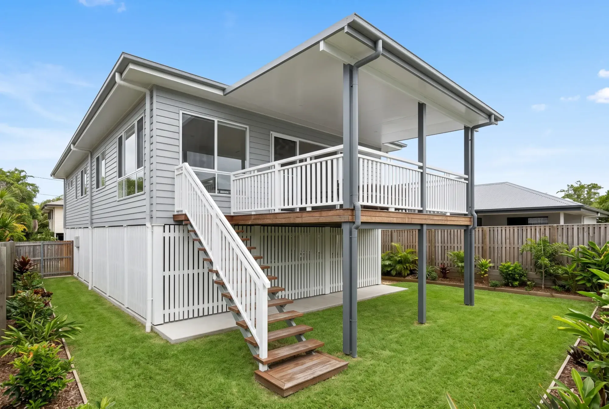 Elevated deck with stairs under a patio roof