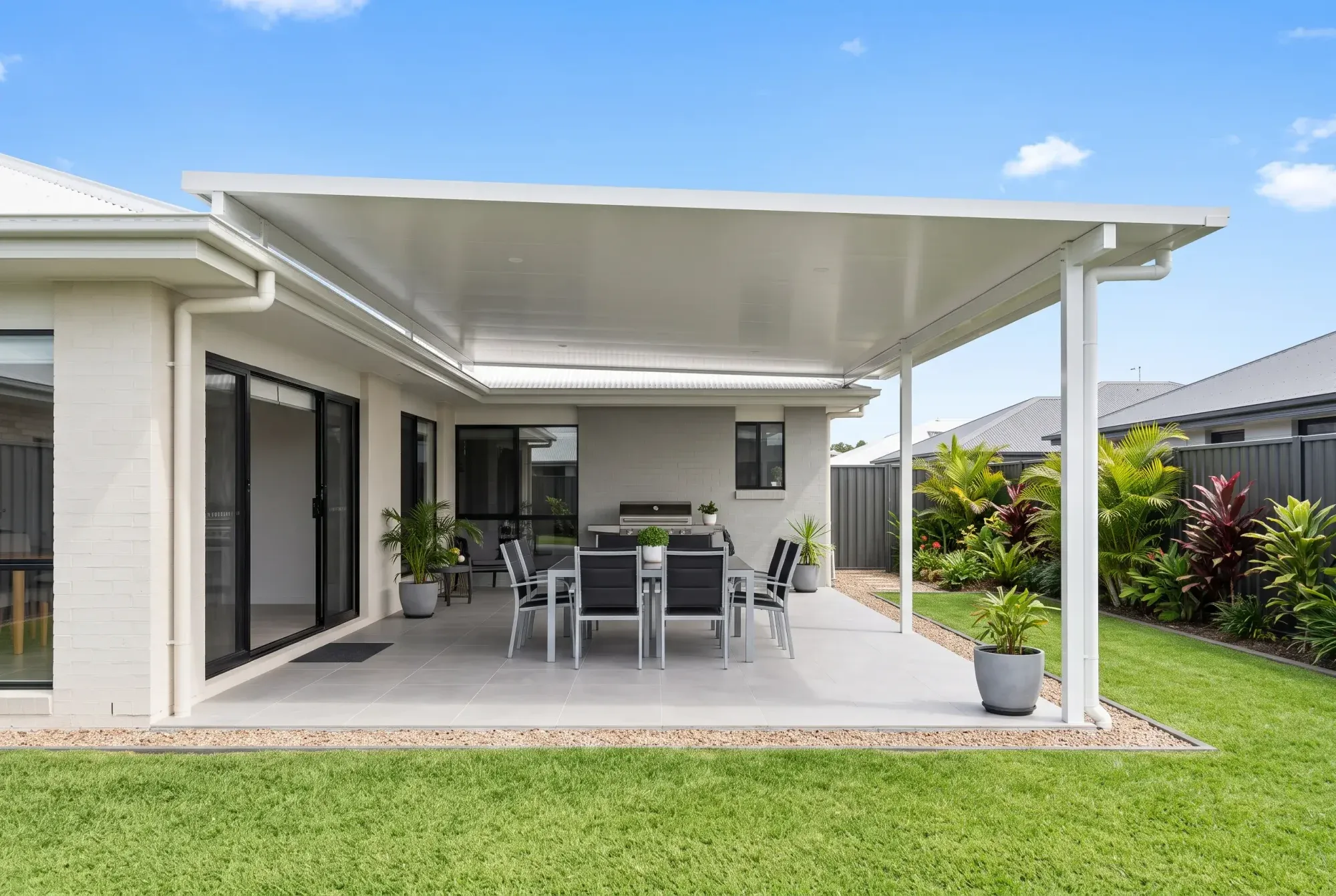 Flat patio roof over an outdoor dining setting