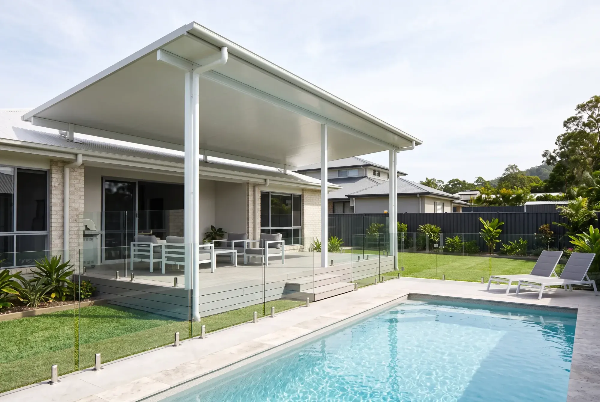 Insulated roof patio beside a pool and deck stairs