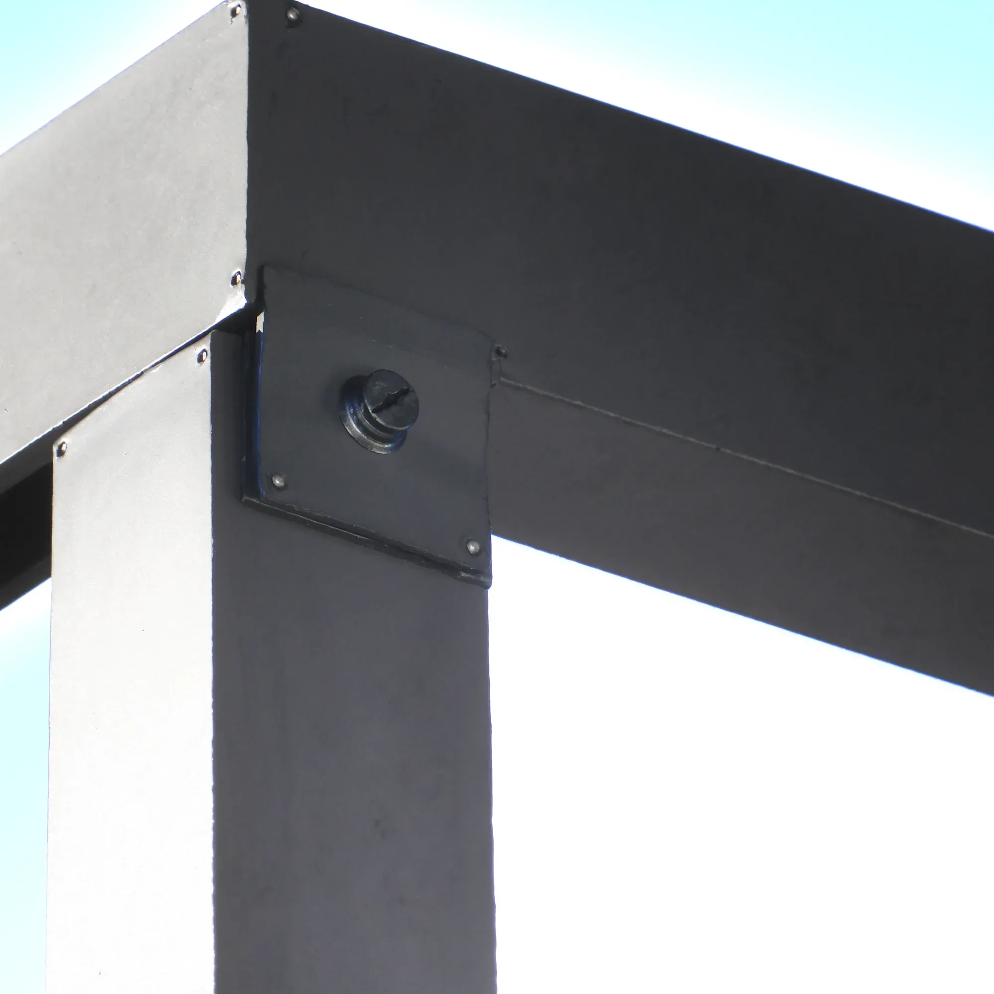 Close detail of a powder-coated steel post-to-beam bracket with galvanised bolts